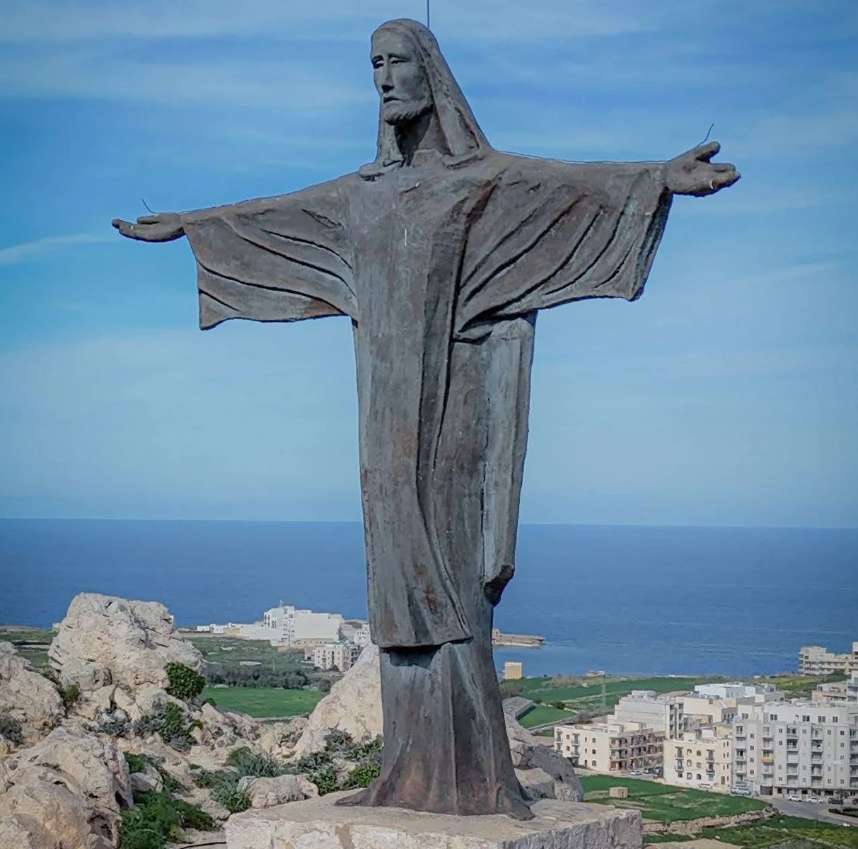 Large coastal statue photographed with the sea behind it